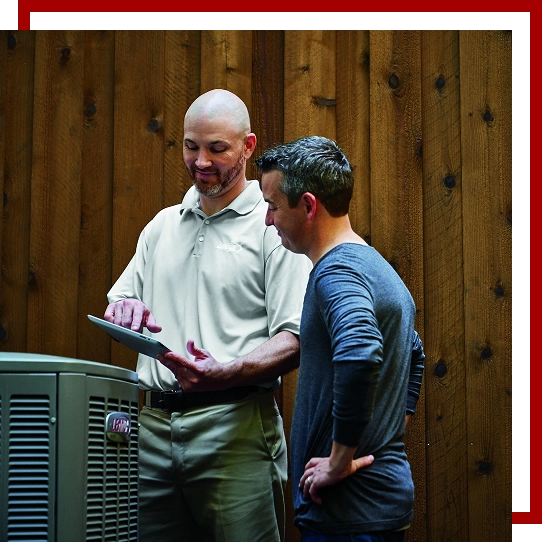 hvac technician wearing blue uniform repairing hvac unit using screwdriver
